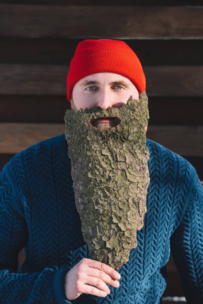 portrait of man with beard made of wood bark looking at camera outdoors - Foto, Imagen