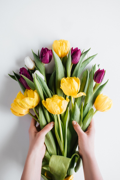 cropped view of hands with bouquet of spring tulips for international womens day - Zdjęcie, obraz