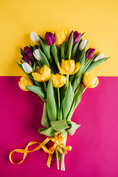 top view of spring tulips with ribbon for international womens day - Photo, Image