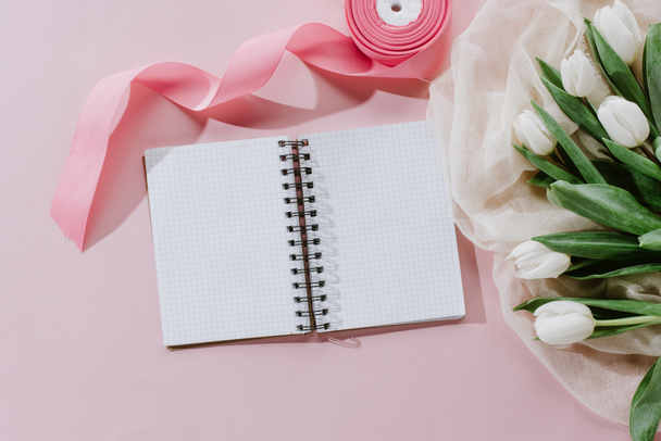 Notizblock, rosa Schleife und weiße Tulpen zum internationalen Frauentag - Foto, Bild