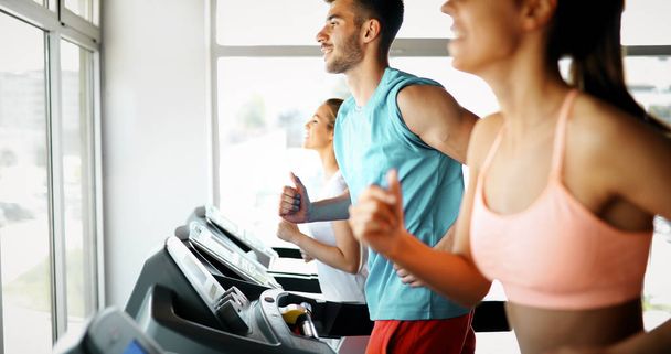  friends exercising on treadmill machine - Foto, Bild