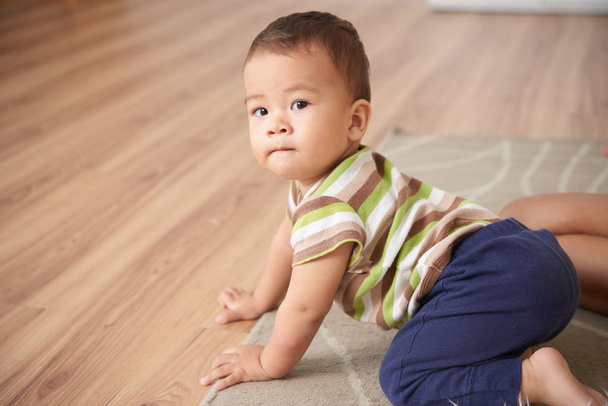 Cute Asian kid crawling on the floor - Photo, Image