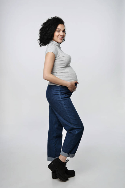 Pregnant woman standing in full length - Fotó, kép