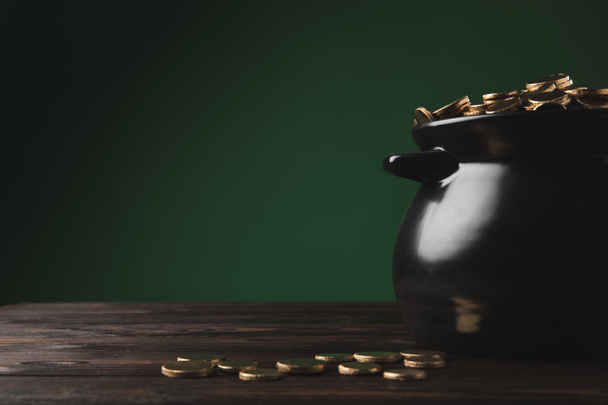 golden coins in pot and on wooden table, st patricks day concept - Foto, Imagen