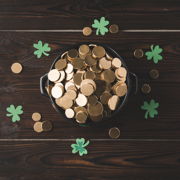 top view of pot with golden coins and shamrock on wooden table, st patricks day concept - Fotografie, Obrázek