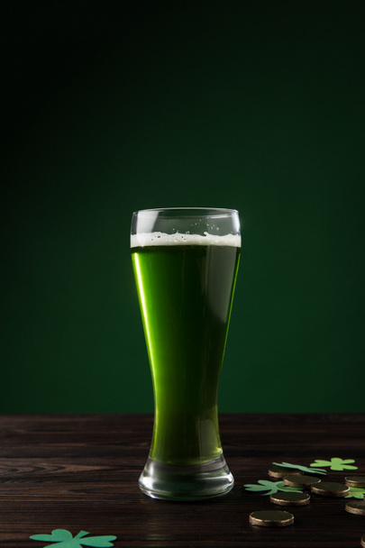 glass of green beer with shamrock and golden coins on table, st patricks day concept - Photo, Image