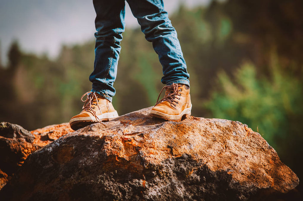 travel concept - little boy hiking boots in mountains - 写真・画像