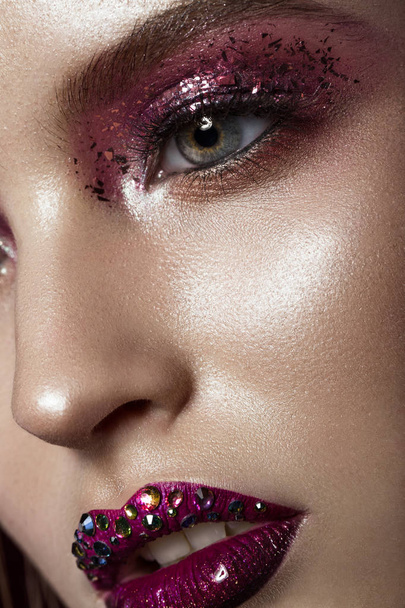 Beautiful girl with creative bright makeup with rhinestones . Beauty face. - Foto, afbeelding