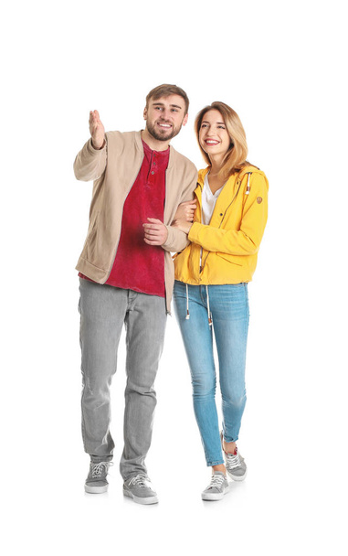 Young couple in casual clothes walking on white background - Photo, Image
