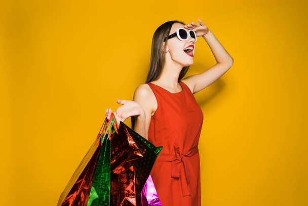 happy woman holding packages with purchases in hands - Photo, image