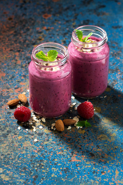 berry smoothie in a bottle and dark background, vertical - Foto, imagen