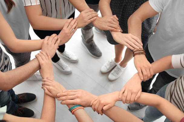 People holding hands together as symbol of unity - Foto, Imagem