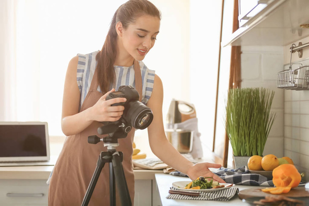 Young woman with professional camera preparing still life composition - Foto, Imagen