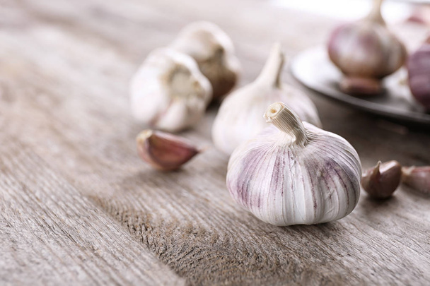 Fresh garlic on wooden table - Фото, изображение