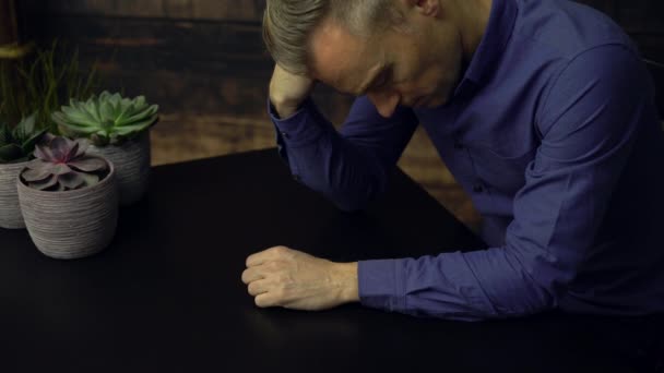 Depressziós ember ül egy asztalnál - Felvétel, videó