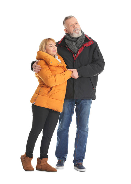 Mature couple in warm clothes walking on white background - Φωτογραφία, εικόνα