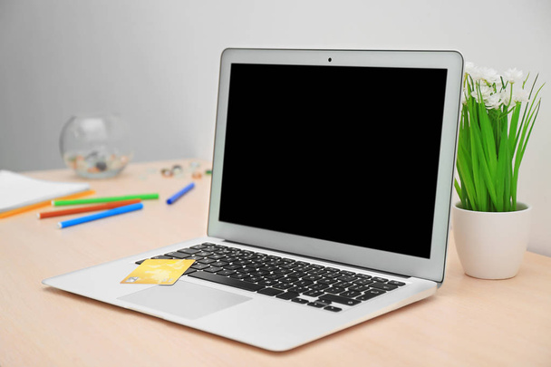 Laptop and credit card on table. Internet shopping concept - Photo, Image