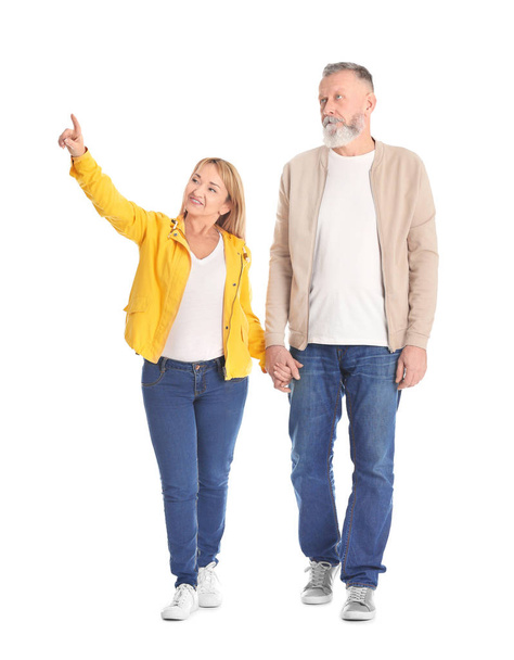 Mature couple in casual clothes walking on white background - Fotografie, Obrázek