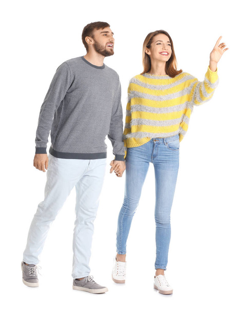 Young couple in casual clothes walking on white background - Foto, immagini