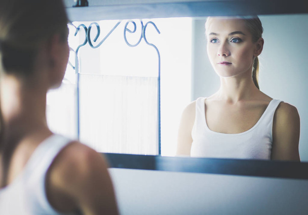 face of young beautiful healthy woman and reflection in the mirror - Foto, Imagen
