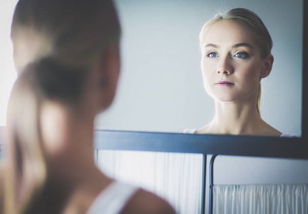 face of young beautiful healthy woman and reflection in the mirror - Фото, изображение