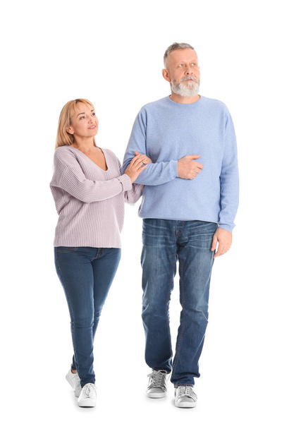 Mature couple in casual clothes walking on white background - Photo, image