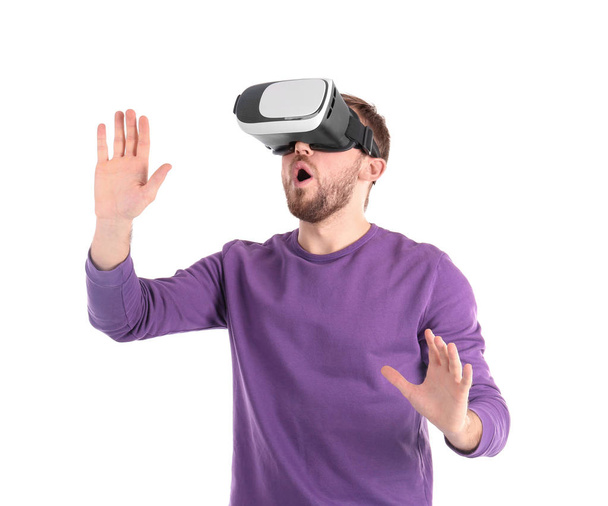 Emotional man with virtual reality headset on white background - Фото, изображение