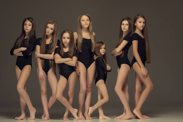 The group of teen girls posing at white studio - Фото, изображение