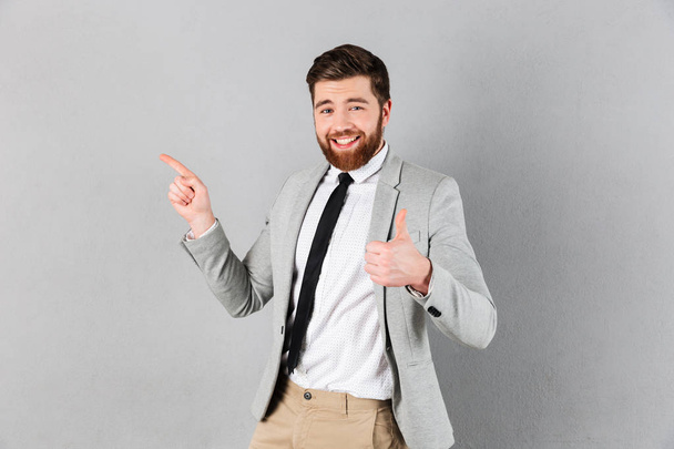 Portrait of an excited businessman dressed in suit - Zdjęcie, obraz