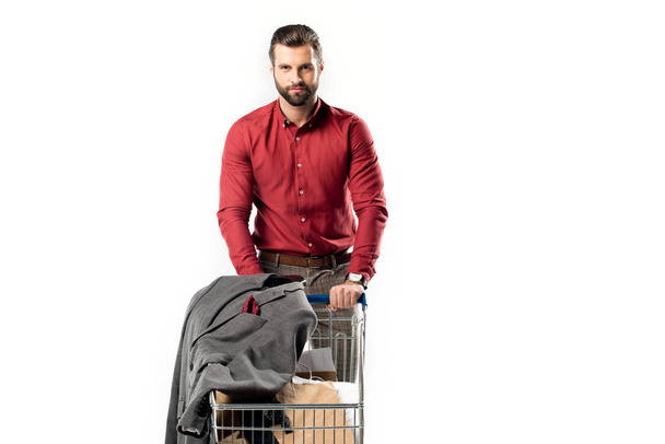 portrait of man with shopping cart full of shopping bags and jacket isolated on white - Fotoğraf, Görsel