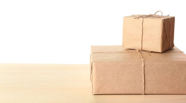 Parcel gift boxes on table against white background - Foto, imagen