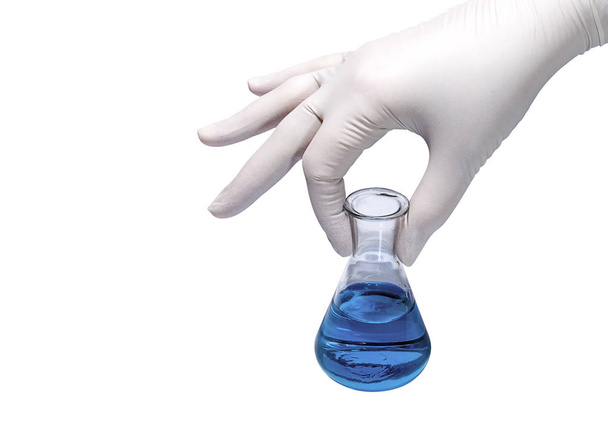 medizinisches Konzept: Hand in Hand Gummihandschuh-Fläschchen mit blauer Flüssigkeit - Foto, Bild