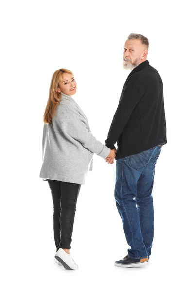 Mature couple in casual clothes walking on white background - Foto, Bild