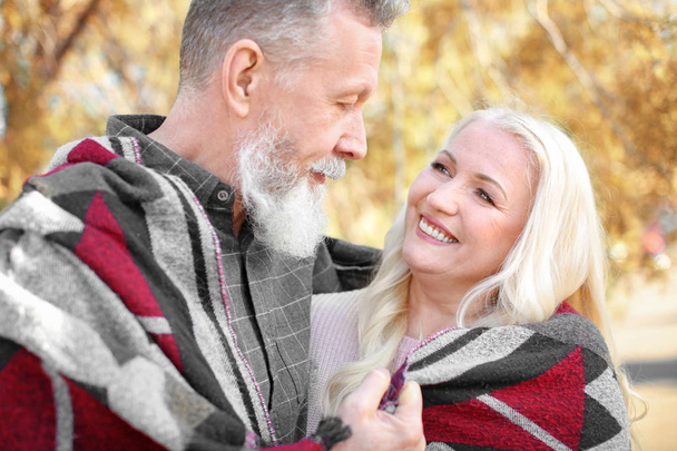 Happy mature couple in autumn park - Zdjęcie, obraz