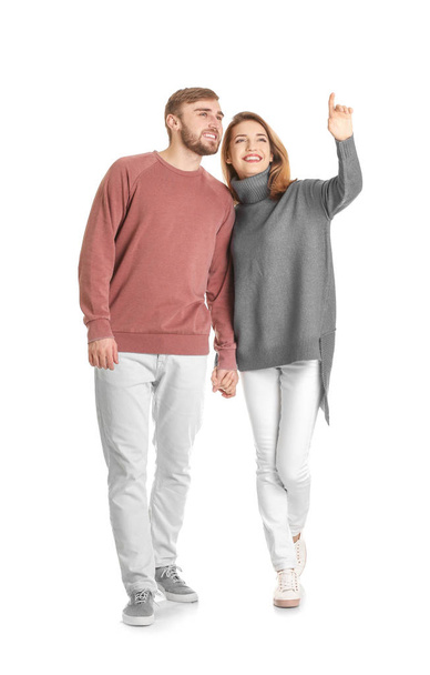 Young couple in casual clothes walking on white background - Foto, Imagen