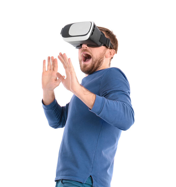 Emotional man with virtual reality headset on white background - Fotoğraf, Görsel
