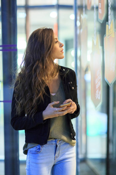 Beautiful brunettelooking in shop window - Fotó, kép