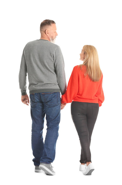 Mature couple in casual clothes walking on white background - Foto, imagen