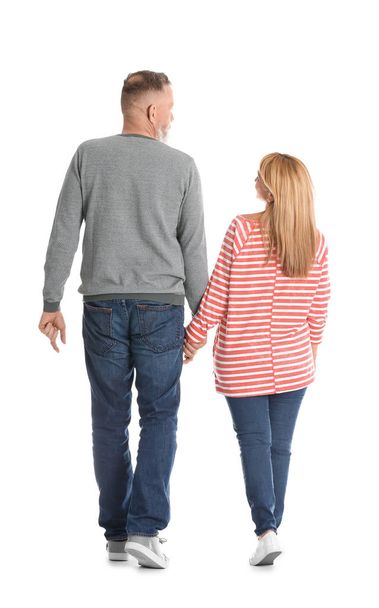 Mature couple in casual clothes walking on white background - 写真・画像