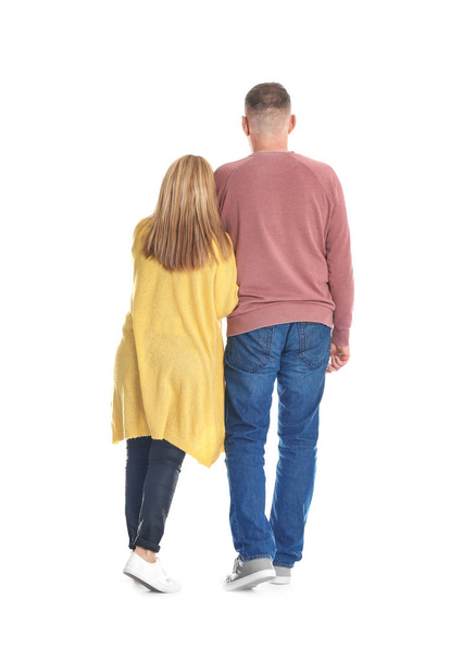 Mature couple in casual clothes walking on white background - Fotoğraf, Görsel