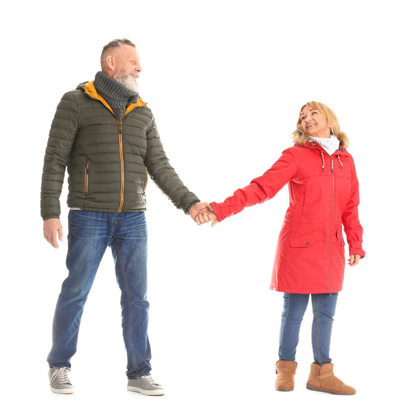 Mature couple in warm clothes walking on white background - Fotografie, Obrázek