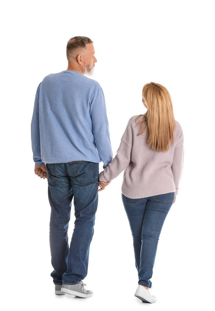 Mature couple in casual clothes walking on white background - Foto, Imagem