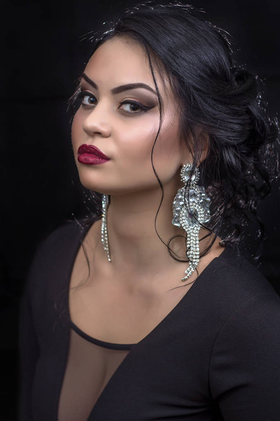 Girl with make up and a jewel on a black  background - Foto, imagen