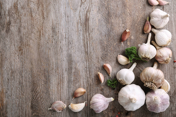 Composition with garlic on wooden background - Фото, изображение