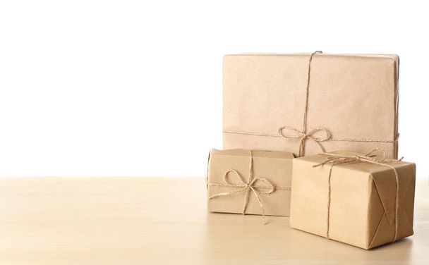 Parcel gift boxes on table against white background - Photo, image