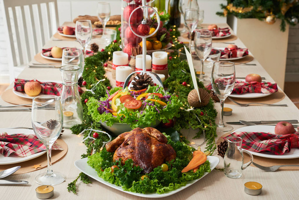Food and decorations on Christmas dinner table - Фото, зображення