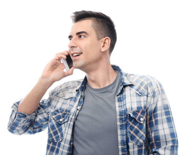 Atractivo joven hablando en el teléfono móvil sobre fondo blanco
 - Foto, Imagen