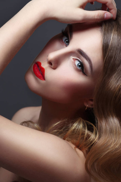 Fashion portrait of woman with curls and red lipstick on black background - Zdjęcie, obraz