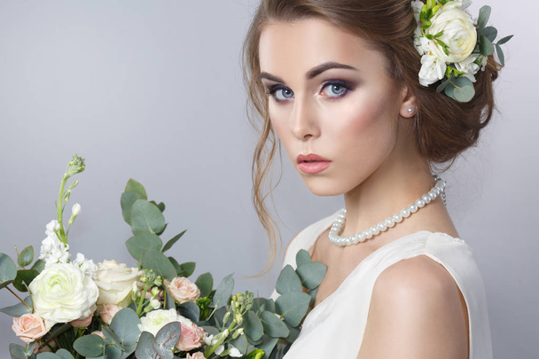 portrait of bride hairstyle with wreath and bouquet in hands on gray background - Φωτογραφία, εικόνα