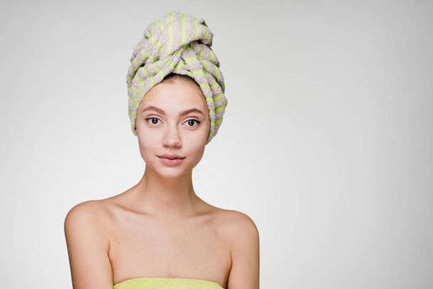 a surprised woman with a towel on her head after a shower - Foto, Bild